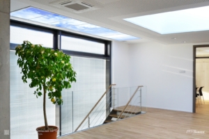 LED-Wolkendecke als langgestrecktes künstliches Oberlicht über einer Treppe.